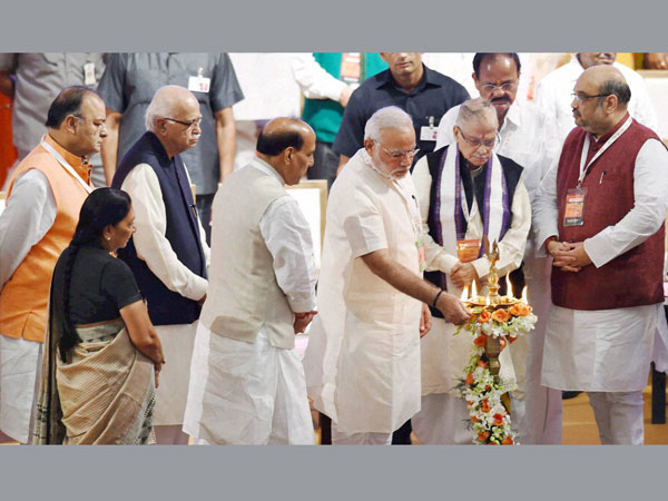 BJP President Amit Shah lights the lamp