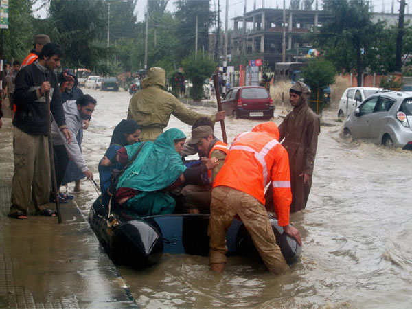 Rescue workers rescue flood-affected people in Srinagar on Friday.