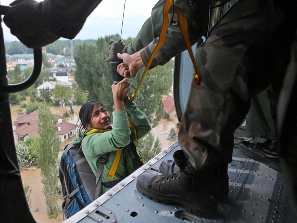 A tourist cries as she is airlifted into a chopper