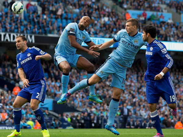 Manchester City's Edin Dzeko, second right and Vincent Kompany Manchester City's Edin Dzeko, second right and Vincent Kompany