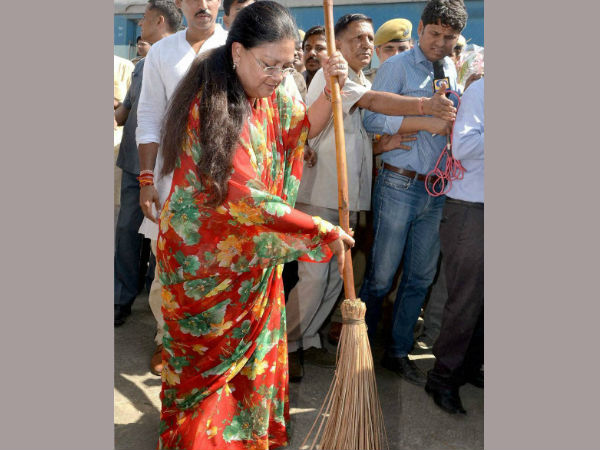 Vasundhara Raje sweeps at a railway station