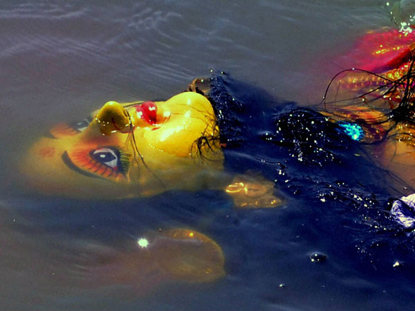 An idol of Goddess Durga being immersed in Tezpur