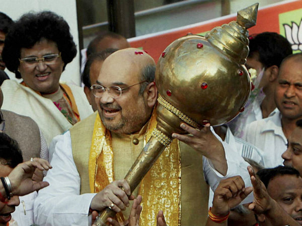BJP President Amit Shah is presented a mace by party workers on his arrival at the party headquarters in New Delhi on Sunday after the party's win in Maharashtra and Haryana polls.