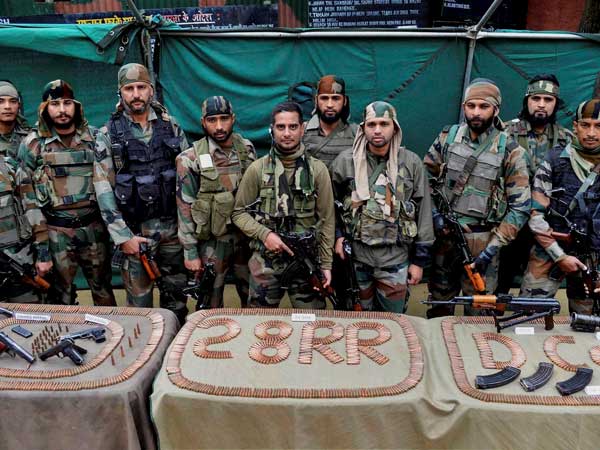 Army soldiers display arms and ammunition recovered