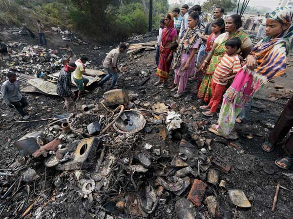 Residents look for their belongings after a fire broke out