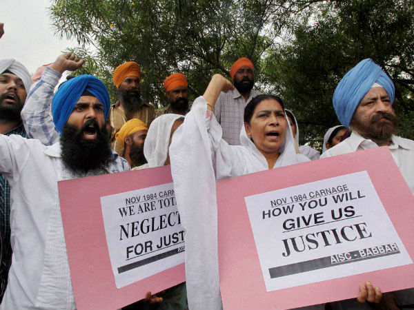 Victims of 1984 anti-Sikh riots shout slogans during a protest demanding justice. (PTI Photo)