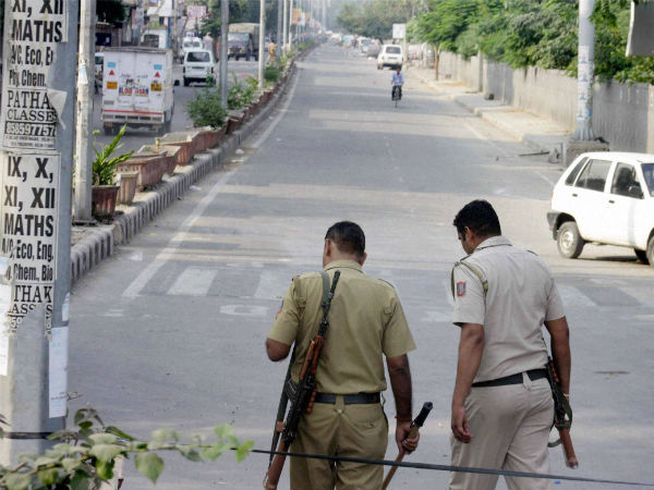 New Delhi: Police men walk in a street during curfew in violence-hit Trilokpuri in New Delhi on Monday. (PTI Photo)