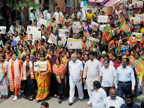 BJP Leader B S Yeduyurappa, R Ashok and MP Shobha Karandlaje along with Mahila Morcha activists protest against the recent sexual harresment cases on children in Bengaluru on Wednesday. BJP Leader B S Yeduyurappa, R Ashok and MP Shobha Karandlaje along with Mahila Morcha activists protest against the recent sexual harresment cases on children in Bengaluru on Wednesday.