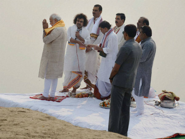Prime Minister Narendra Modi offers prayers with priests during at the Assi Ghat in Varanasi on Saturday.