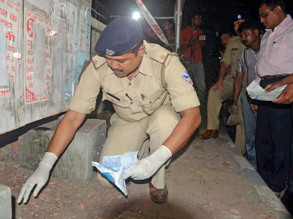 Police officials investigates at the blast side after a powerful explosion outside the Central Reserve Police Force (CRPF) camp, where the National Investigation Agency (NIA) officials probing Bardhaman blast case main accused Sajid Khan is under NIA custody at Salt lake area under North 24 pargana district near Kolkata