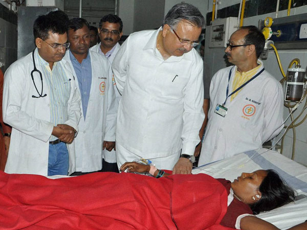 Chhattisgarh Chief Minister Raman Singh meets a woman who underwent sterilization surgeries receive treatment at the CIMS hospital in Bilaspur, Chhattisgarh on Tuesday.