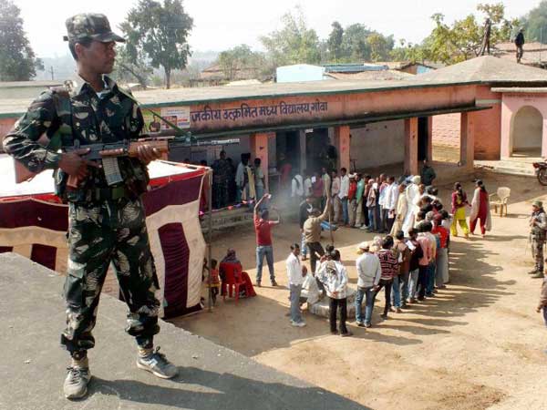 A security person stands guard outside a polling station