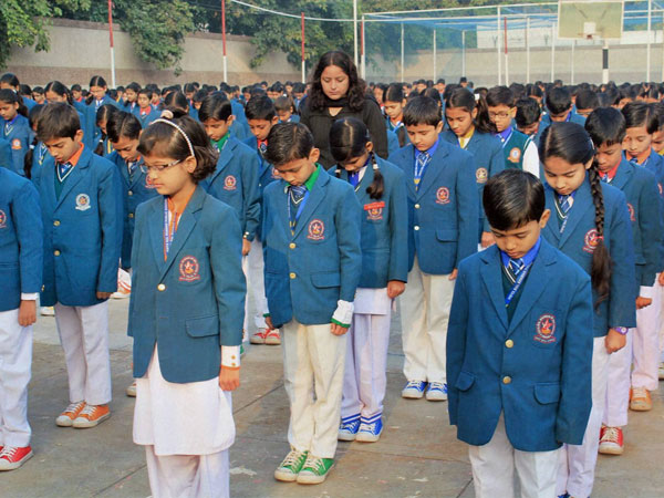 School Children pray for the victims of a Taliban attack