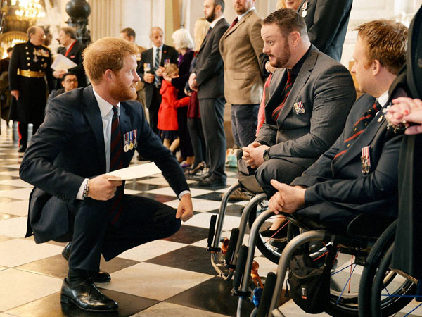 Britain's Prince Harry, left, talks to Sapper Clive Smith, 2nd right, and Sapper Jack Cummings, right, who both lost their legs in Afghanistan in 2010 at St Paul's Cathedral, London, following a service marking the 75th anniversary of Explosive Ordnance Disposal (EOD) across the Armed Forces. Britain's Prince Harry, left, talks to Sapper Clive Smith, 2nd right, and Sapper Jack Cummings, right, who both lost their legs in Afghanistan in 2010 at St Paul's Cathedral, London, following a service marking the 75th anniversary of Explosive Ordnance Disposal (EOD) across the Armed Forces.