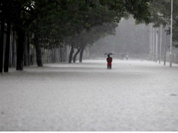 Chennai rains: Man walking on a submerged road