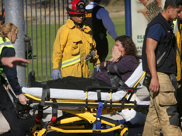 A victim is wheeled away on a stretcher following a shooting that killed multiple people at a social services facility. A victim is wheeled away on a stretcher following a shooting that killed multiple people at a social services facility.