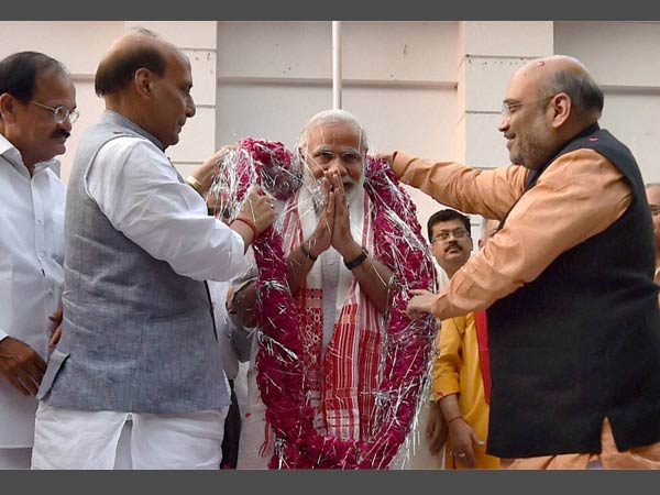 Prime Minister Narendra Modi being garlanded by BJP president Amit Shah and Union minister & senior leader Rajnath Singh before a meeting at the party office in New Delhi on Thursday following Assembly poll results of the five states. Prime Minister Narendra Modi being garlanded by BJP president Amit Shah and Union minister & senior leader Rajnath Singh before a meeting at the party office in New Delhi on Thursday following Assembly poll results of the five states.