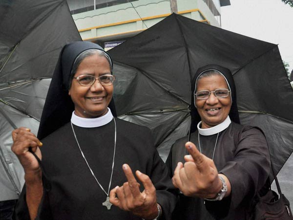 Catholic nuns show their fingers after casting votes outside a polling booth during the assembly elections in Kochi, Kerala on Monday. Catholic nuns show their fingers after casting votes outside a polling booth during the assembly elections in Kochi, Kerala on Monday.