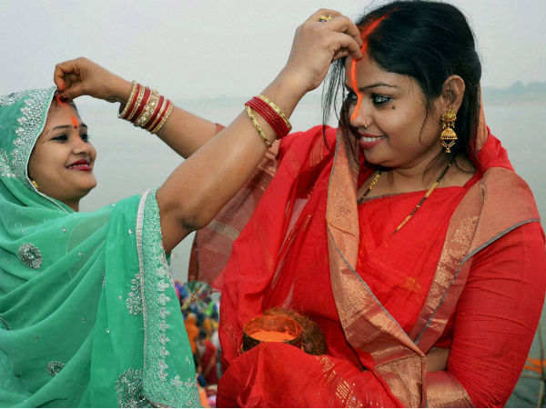 Woman devotees put vermillion on eachothers' forehead