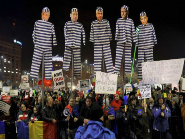 Demonstrators carry puppets Demonstrators carry puppets