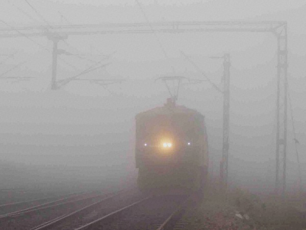 A train moves slowly amid a thick blanket of fog on a cold morning, in Allahabad. A train moves slowly amid a thick blanket of fog on a cold morning, in Allahabad.
