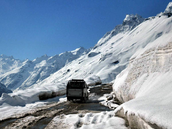 A vehicle passes through Rohtang pass, in Manali A vehicle passes through Rohtang pass, in Manali