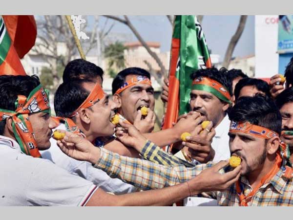 Supporters distribute sweets Supporters distribute sweets