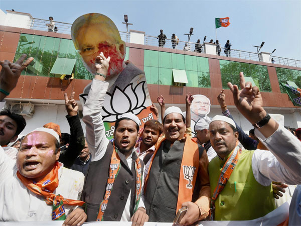 BJP supporters celebrate as early trends show the party's win in the Uttar Pradesh and Uttarakhand assembly polls, at the party office in Lucknow. BJP supporters celebrate as early trends show the party's win in the Uttar Pradesh and Uttarakhand assembly polls, at the party office in Lucknow.