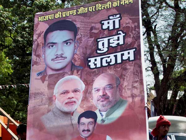 Workers carry a hoarding outside Delhi BJP office Workers carry a hoarding outside Delhi BJP office