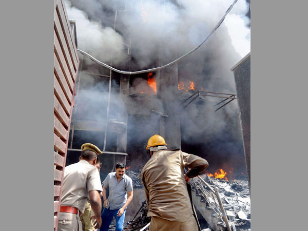Firefighters douse a fire that broke out in a factory in Noida. Firefighters douse a fire that broke out in a factory in Noida.