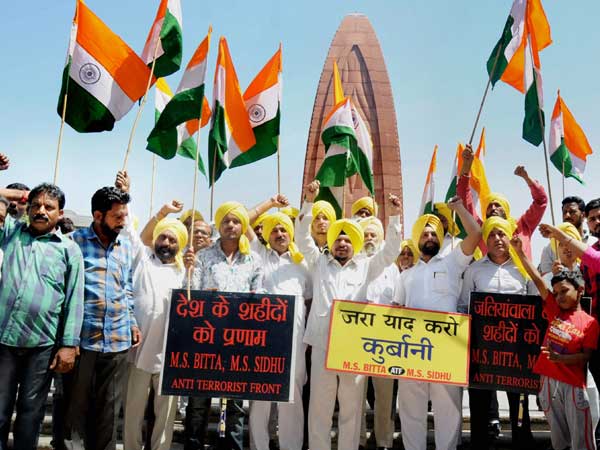Activists of All India Anti Terrorist Front (AIATF) hold national flags as they shout patriotic slogans to pay tributes to the martyrs on the eve of the anniversary of the Jallianwala Bagh massacre, at the Jallianwala Bagh Martyrs' memorial in Amritsar. Activists of All India Anti Terrorist Front (AIATF) hold national flags as they shout patriotic slogans to pay tributes to the martyrs on the eve of the anniversary of the Jallianwala Bagh massacre, at the Jallianwala Bagh Martyrs' memorial in Amritsar.