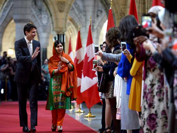 Pakistani activist and Nobel Peace Prize winner Malala Yousafzai, right, walks through the hall of honour with Prime Minister Justin Trudeau on Parliament Hill in Ottawa. Pakistani activist and Nobel Peace Prize winner Malala Yousafzai, right, walks through the hall of honour with Prime Minister Justin Trudeau on Parliament Hill in Ottawa.
