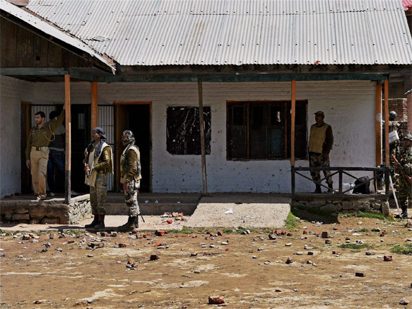 CRPF personnel standing guard at a polling station during repoll in Srinagar Lok Sabha constituency in Budgam district of Kashmir CRPF personnel standing guard at a polling station during repoll in Srinagar Lok Sabha constituency in Budgam district of Kashmir