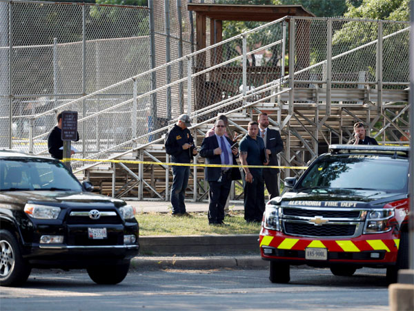 Law enforcement officers investigate the scene of a shooting near a baseball field in Alexandria Law enforcement officers investigate the scene of a shooting near a baseball field in Alexandria