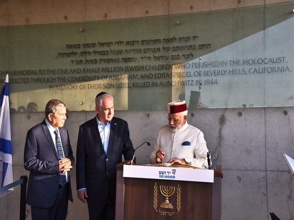 Modi writing in the visitors' book at the memorial
