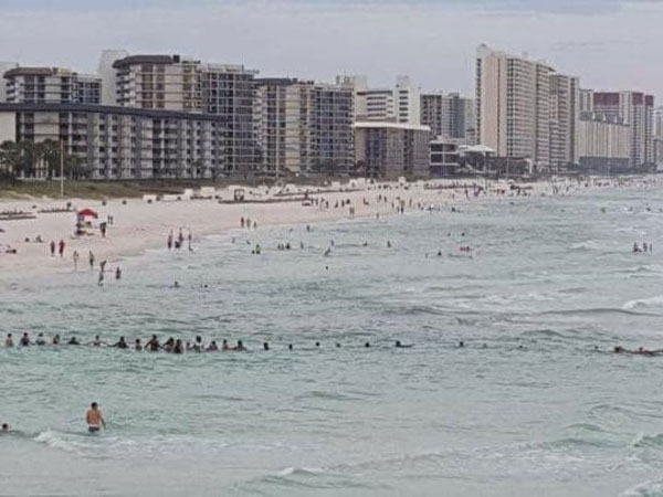Strangers form a human chain to help save nine people caught in rip current. Strangers form a human chain to help save nine people caught in rip current.