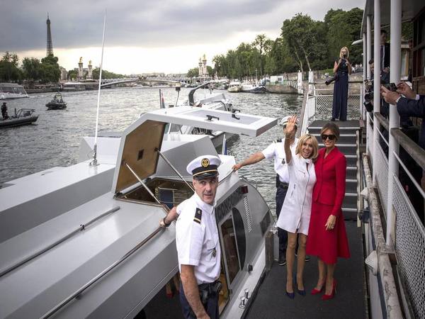 US First Lady Melania Trump, right, and French president's wife Brigitte Macron wave after a boat trip down the River Seine in Paris US First Lady Melania Trump, right, and French president's wife Brigitte Macron wave after a boat trip down the River Seine in Paris