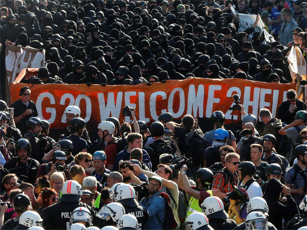 Black dressed demonstrators and police face each other during a protest titled "G20 Welcome to hell" against the G-20 summit in Hamburg, northern Germany. PTI file photo Black dressed demonstrators and police face each other during a protest titled "G20 Welcome to hell" against the G-20 summit in Hamburg, northern Germany. PTI file photo