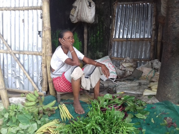 A vegetable seller awaits customers A vegetable seller awaits customers