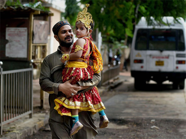 A man carries a girl, dressed as Radha, after Janmashtami celebrations in a school in Mumbai on Monday. PTI Photo by Shashank Parade A man carries a girl, dressed as Radha, after Janmashtami celebrations in a school in Mumbai on Monday. PTI Photo by Shashank Parade
