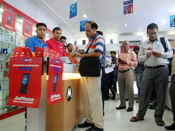 People filling forms to buy JIO mobile phones in New Delhi People filling forms to buy JIO mobile phones in New Delhi