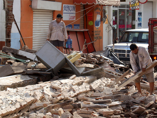 A man removes debris from a collapsed building felled by a massive earthquake, in Juchitan, Oaxaca state, Mexico, Friday, Sept. 8, 2017. One of the most powerful earthquakes ever to strike Mexico has hit off its southern Pacific coast, killing at least 32 people, toppling houses, government offices and businesses. A man removes debris from a collapsed building felled by a massive earthquake, in Juchitan, Oaxaca state, Mexico, Friday, Sept. 8, 2017. One of the most powerful earthquakes ever to strike Mexico has hit off its southern Pacific coast, killing at least 32 people, toppling houses, government offices and businesses.