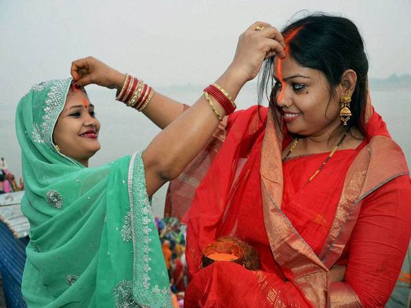 Woman devotees put vermillion on eachothers' forehead
