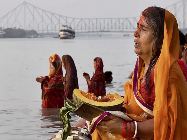 Woman gives 'Arghya' to rising sun