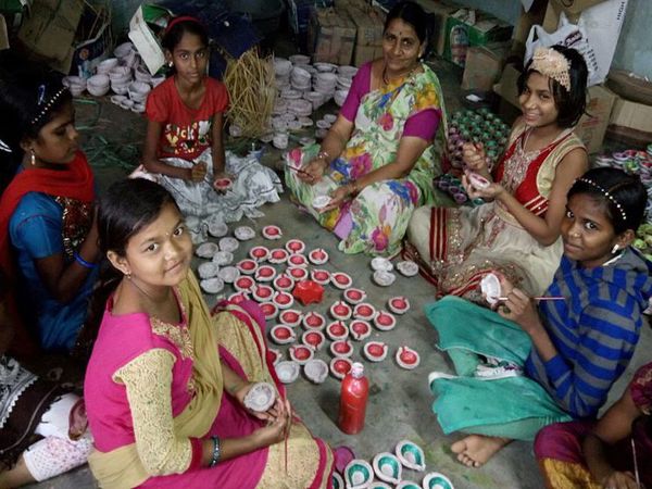 Children being helped by care-takers of the ashram