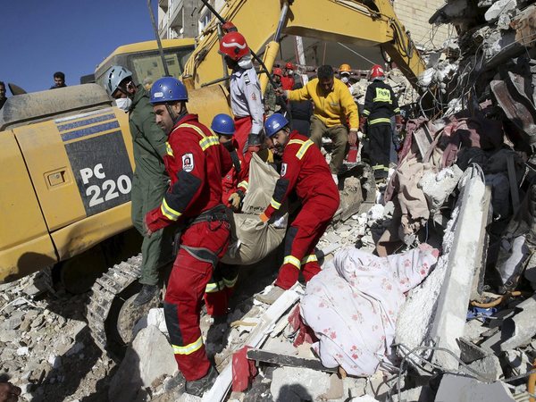 Rescuers carry body of victim