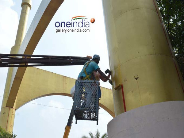 Labourers busy painting the pillars