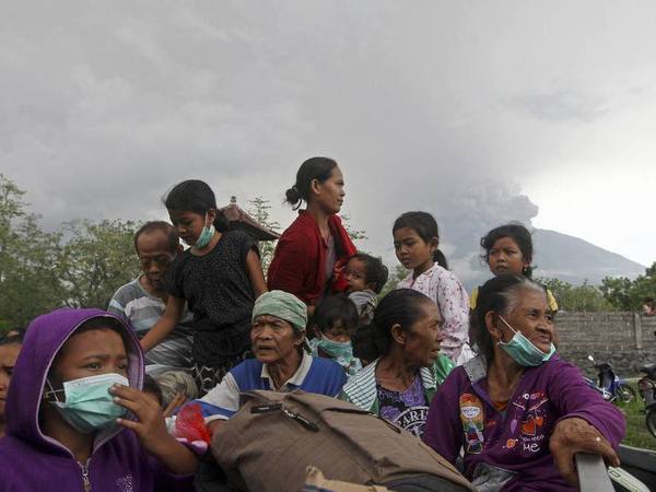 Villagers sit on a truck during evacuation Villagers sit on a truck during evacuation