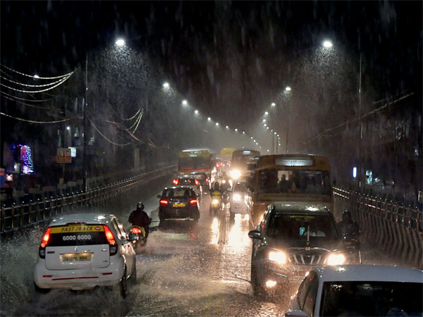 Vehicles move through a waterlogged road during heavy rain in Chennai Vehicles move through a waterlogged road during heavy rain in Chennai