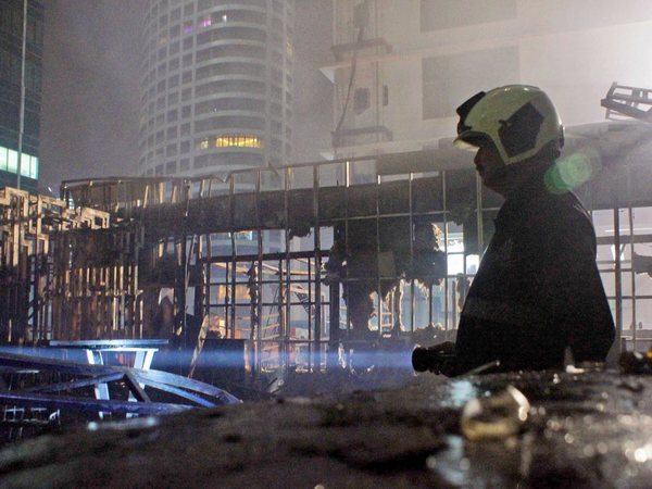 A fireman assists in rescue operations after fire broke out